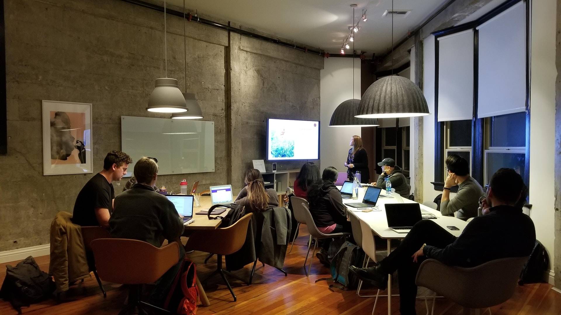 Office photo of employees working together in a modern and collaborative workspace